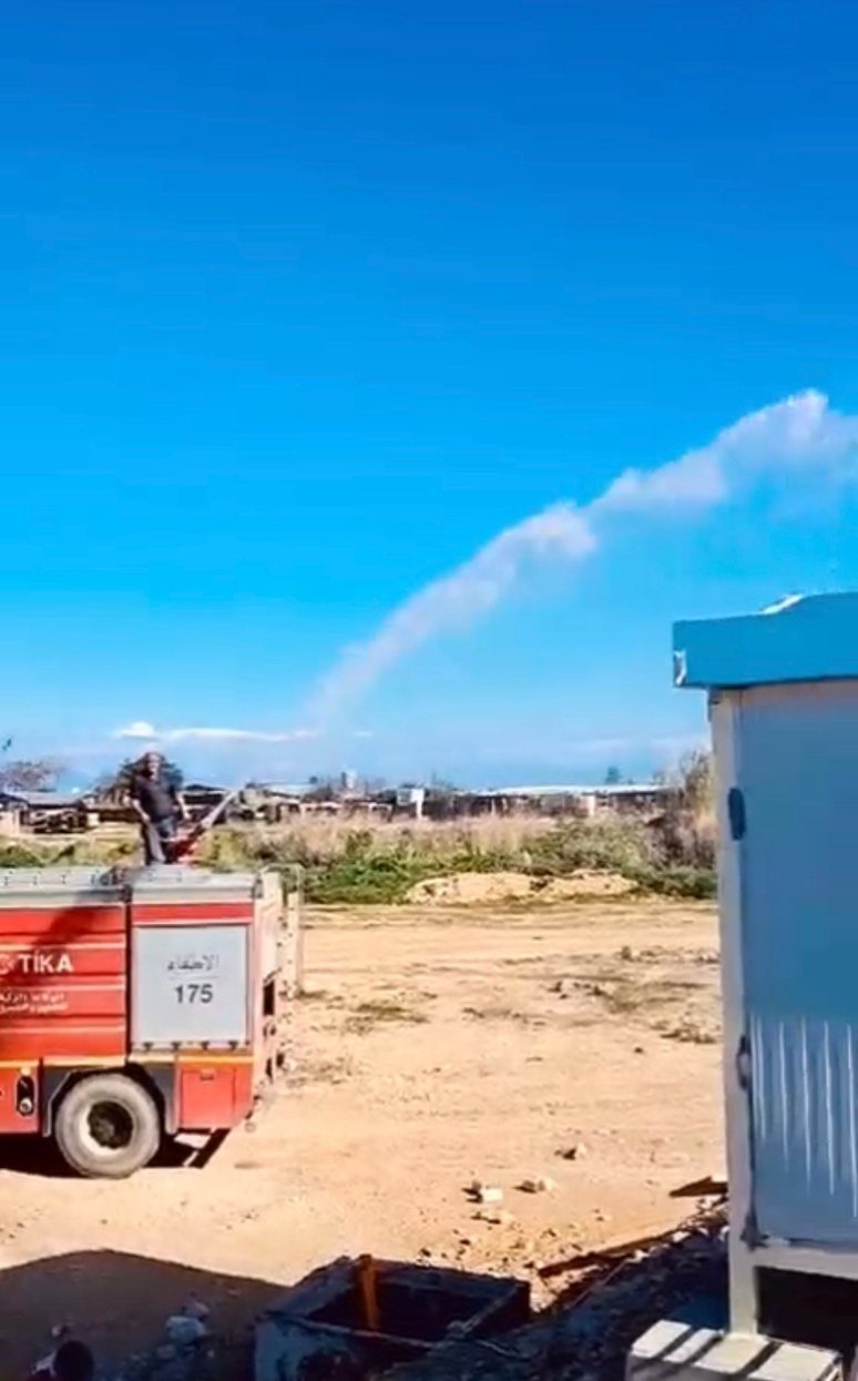 Fire truck spraying a prefabricated cabin to test for leaks